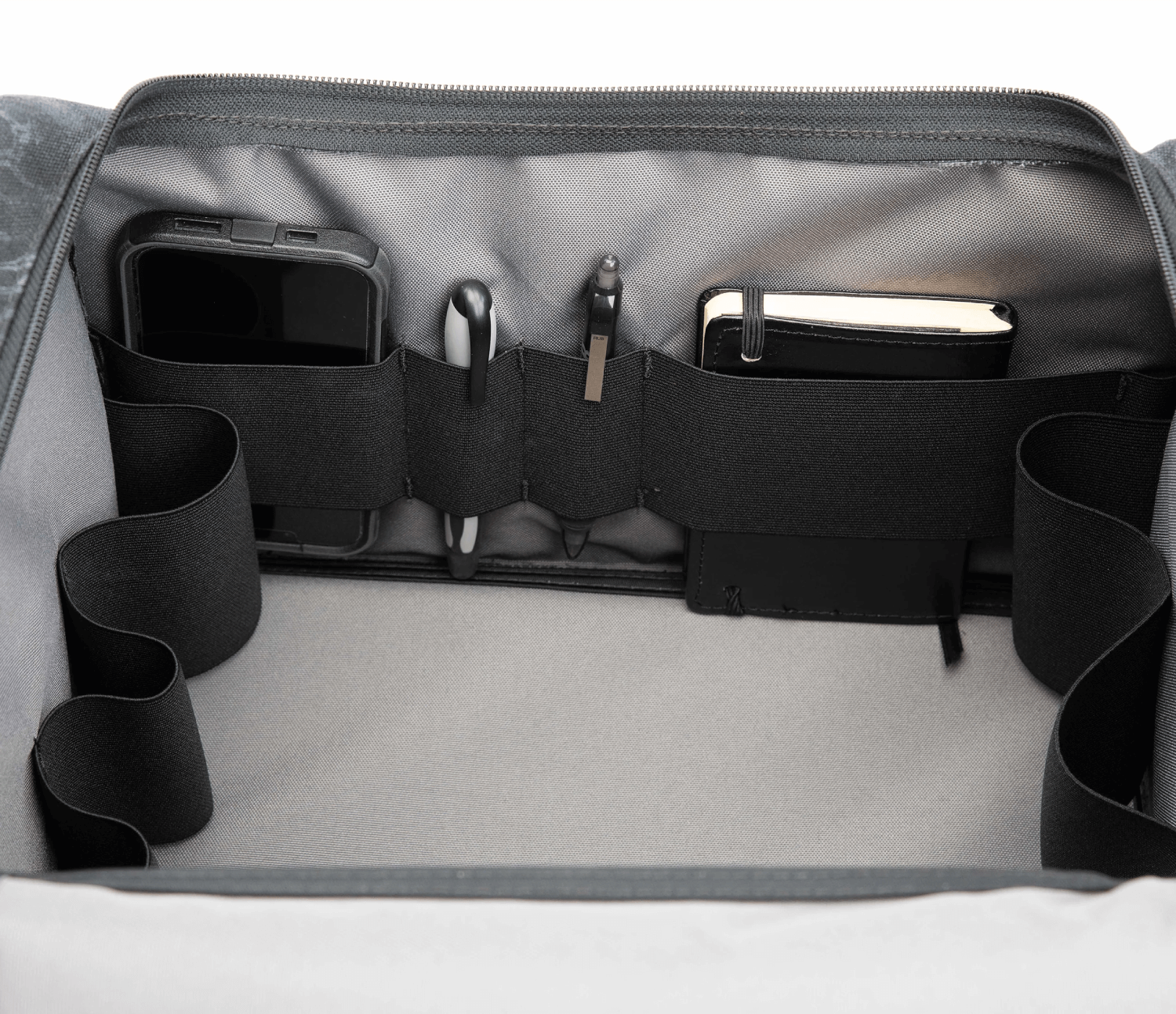 Inside look at S3 Range Cart Bag with accessory straps highlighted with a phone, pens, and notepad