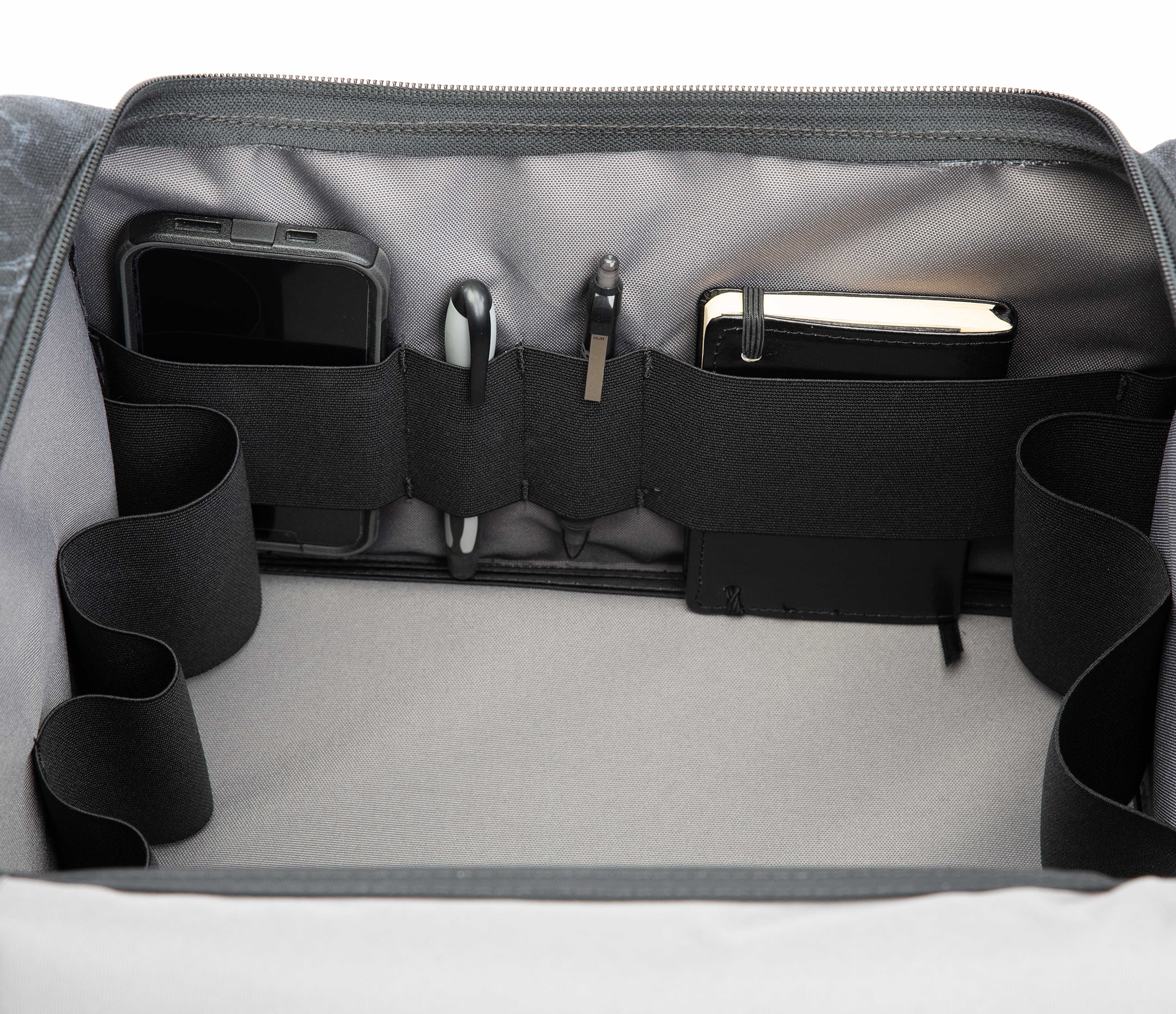 Inside of Patriot edition of S3 Range Cart showing off accessory holder with a phone, pens and book