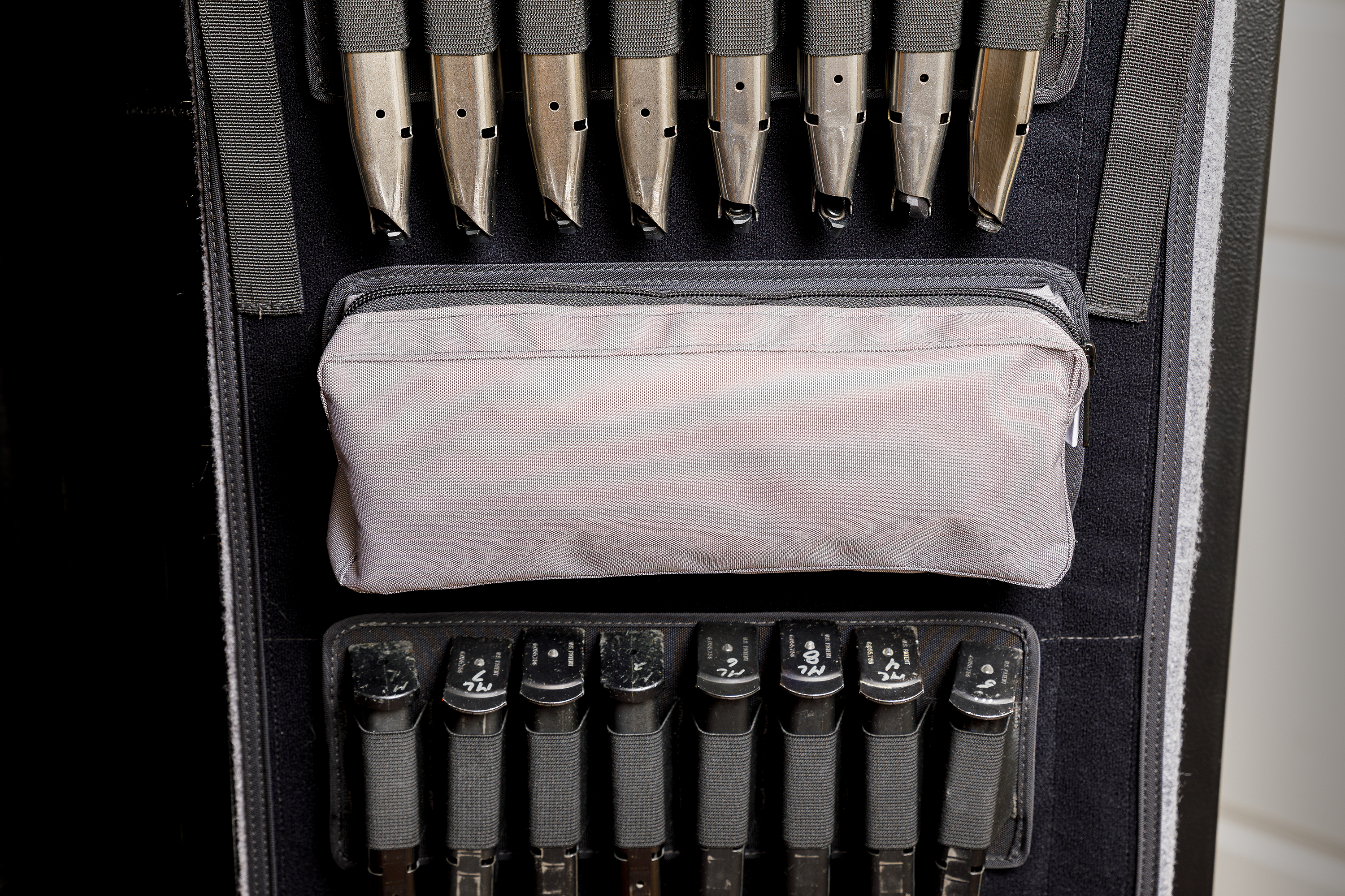 Gun safe organizer with zip pocket displayed on gun safe door panel