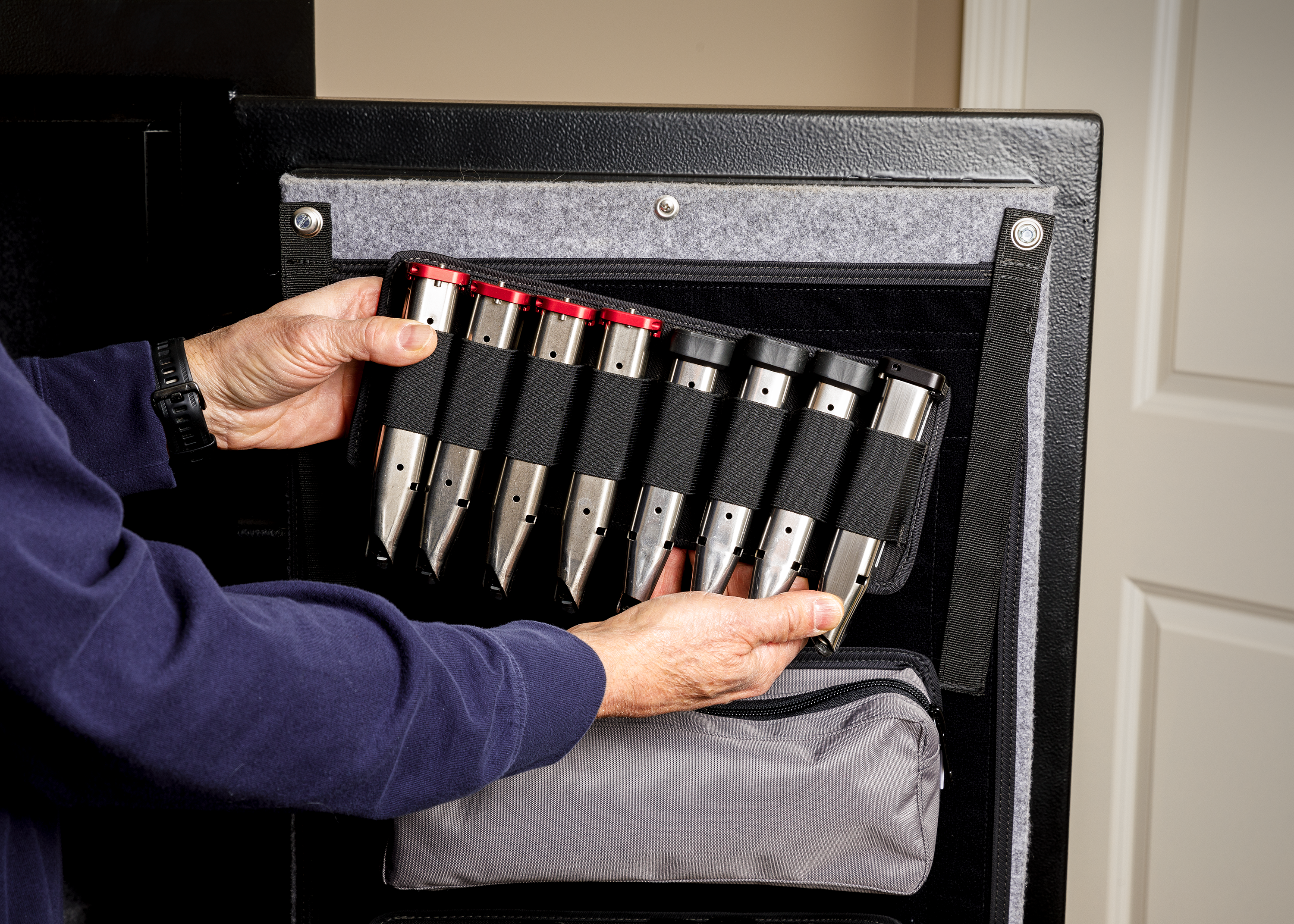 Mag sleeve holder being installed on gun safe door