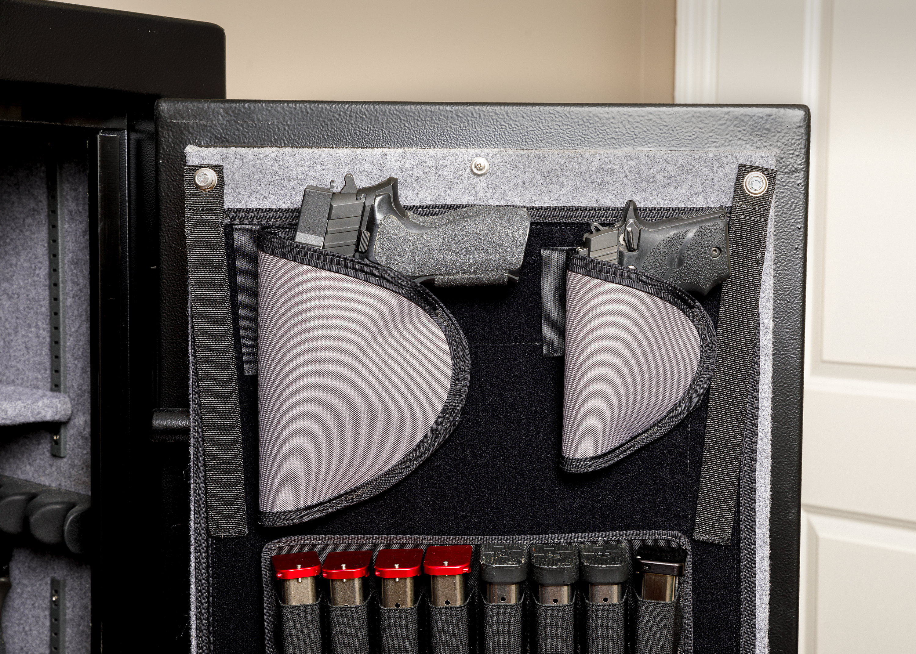 Pistol hanger for gun safe door displayed on gun safe door